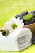 Spa,  flower on the towel, and a bowl with black stones
