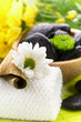 Spa,  flower on the towel, and a bowl with black stones
