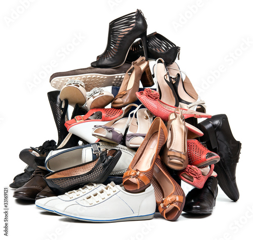 Photo: Pile of various female and male shoes over white Pile of various female and male shoes over white