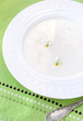 Oatmeal porridge, decorated with violets on an olive napkin