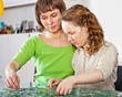 Girl and mom doing puzzle