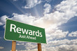 Rewards Green Road Sign Against Clouds Rewards Green Road Sign Against Clouds