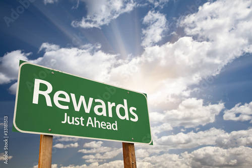 Photo: Rewards Green Road Sign Against Clouds Rewards Green Road Sign Against Clouds
