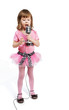Little girl in pink with microphone sings a song.