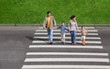 parents holds hand of little daughter and son and crossing
