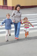 mother holds hand of little daughter and son in city mother holds hand of little daughter and son in city