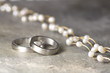 Wedding rings and pearl necklace