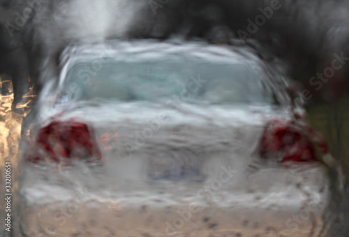 Photo: white car driving in a rain white car driving in a rain