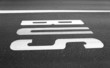 Bus stop sign painted on asphalt road