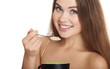 Photo: portrait of young caucasian woman eating cereals portrait of young caucasian woman eating cereals