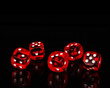 Red playing dices isolated on black background