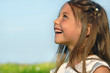 Little happy girl singing on the meadow