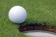 Golfball almost in the hole Golfball almost in the hole