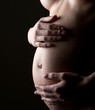 Photo: Pregnant woman holding abdomen Pregnant woman holding abdomen