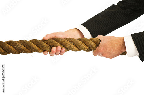 Photo: businessman gripping rope businessman gripping rope