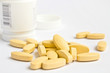 yellow pills on white background