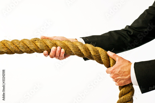 Photo: businessman holding rope businessman holding rope