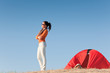 Camping happy woman outside tent on beach