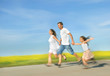 Photo: Happy family running on meadow Happy family running on meadow