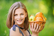 Woman holds basket with fruit