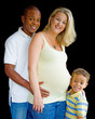 Portrait of mixed race family with pregnant mother