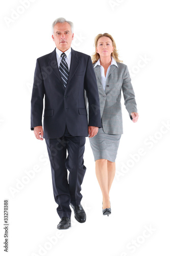 Photo: businessman and businesswoman walking businessman and businesswoman walking