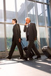 Photo: two businessman with trolley two businessman with trolley