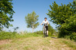 Young girl riding a bike on a field path - offroad