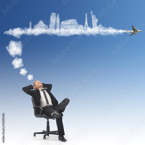 Photo: Business man dreaming about his holidays Business man dreaming about his holidays