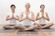 Interracial Group of Three Beautiful Women In Yoga Position