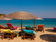 multi-colored deck chairs on the beaches of Greece. Mykonos.