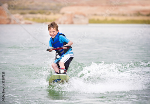 Photo: Young Boy learning to Wakeboard Young Boy learning to Wakeboard