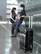 Asian Chinese couple waiting leisurely at the airport Asian Chinese couple waiting leisurely at the airport