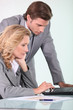 businessman and businesswoman looking at laptop