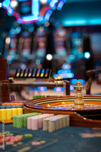 Photo: roulette wheel table with chips piles roulette wheel table with chips piles