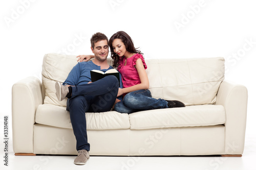 Photo : smiling couple reading from book smiling couple reading from book