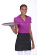 Waitress in a cafe holding an empty tray