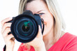 pretty female photographer with her digital camera