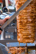 Chef slicing Turkish doner kebab.