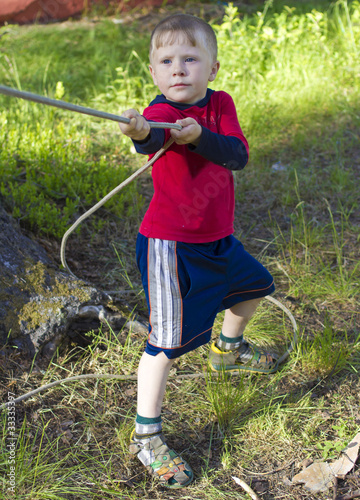 Photo: Little boy pulls the rope by hand