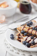 Freshly prepared crepes with blueberries & chocolate sauce