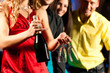 People with drinks in bar or club