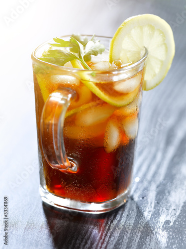 Photo: iced tea with lemon slice and leaf garnish. iced tea with lemon slice and leaf garnish.