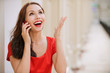 Photo: Young woman talks by mobile phone Young woman talks by mobile phone