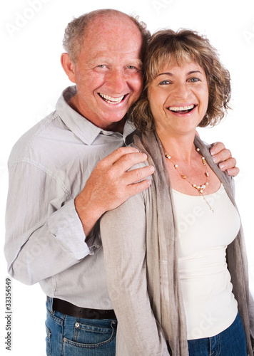 Photo: Happy senior couple smiling at camera Happy senior couple smiling at camera