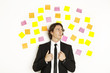 young businessman with postit reminder notes on the background young businessman with postit reminder notes on the background