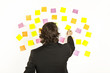 young businessman with postit reminder notes on the background young businessman with postit reminder notes on the background