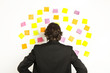 young businessman with postit reminder notes on the background young businessman with postit reminder notes on the background