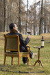man sitting on the chair drinking wine