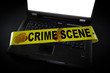 laptop with crime scene tape across it and fingerprints